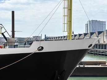 Photo of Ships moored in sea port on sunny day