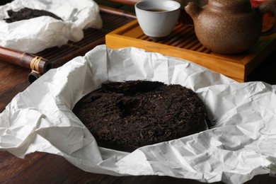 Photo of Disc shaped pu-erh tea on wooden table