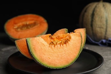 Photo of Slices of fresh ripe cantaloupe melon on grey table