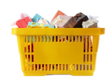 Photo of Shopping basket full of gift boxes on white background