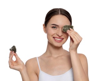 Photo of Young woman with green tea bags on white background. Eye skin care