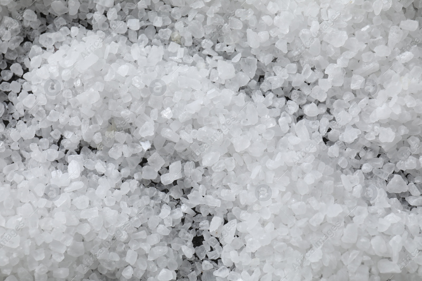 Photo of White natural salt as background, top view