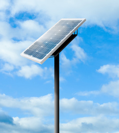 Image of Modern solar panel and blue cloudy sky on background. Alternative energy source