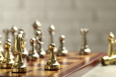 Chessboard with game pieces on light background