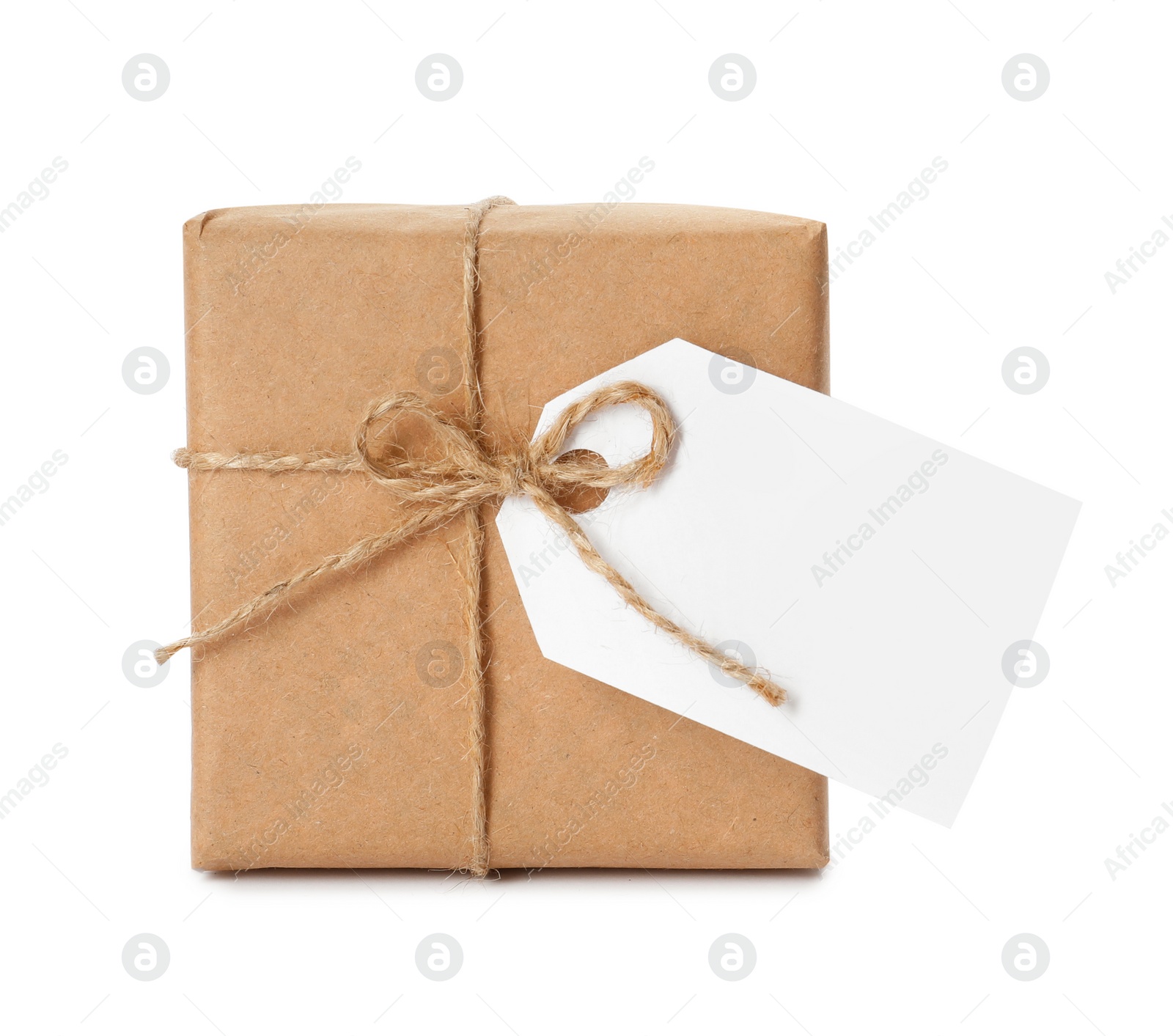 Photo of Gift box wrapped in kraft paper with bow and tag isolated on white