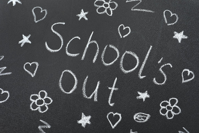 Photo of Words School's Out and pictures on blackboard. Summer holidays