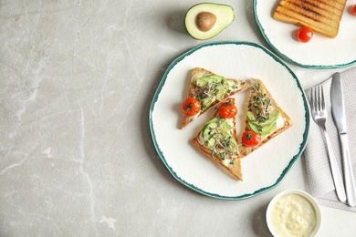 Tasty toasts with avocado, sprouts and chia seeds served on table, top view. Space for text