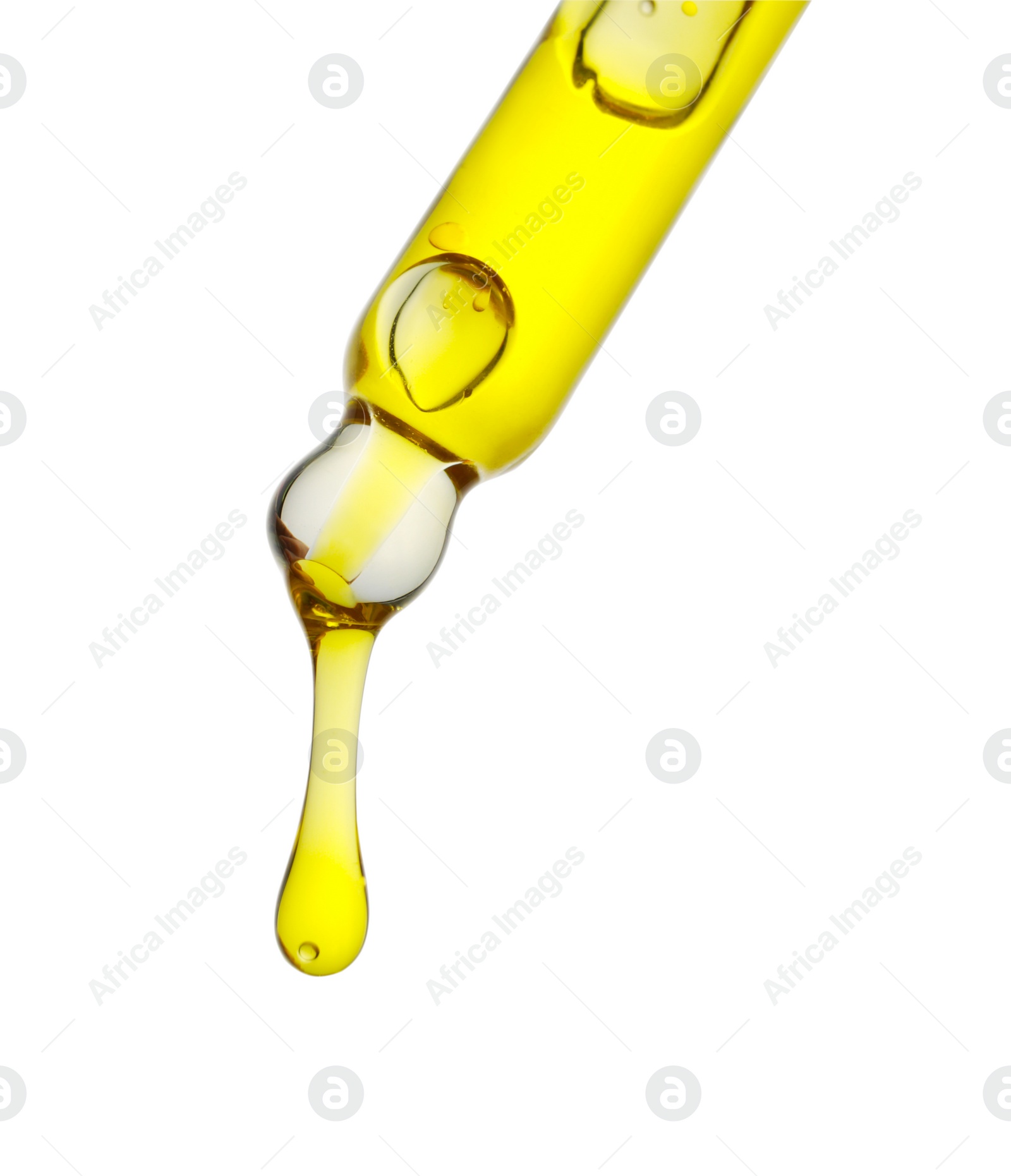 Photo of Dripping yellow facial serum from pipette on white background, closeup