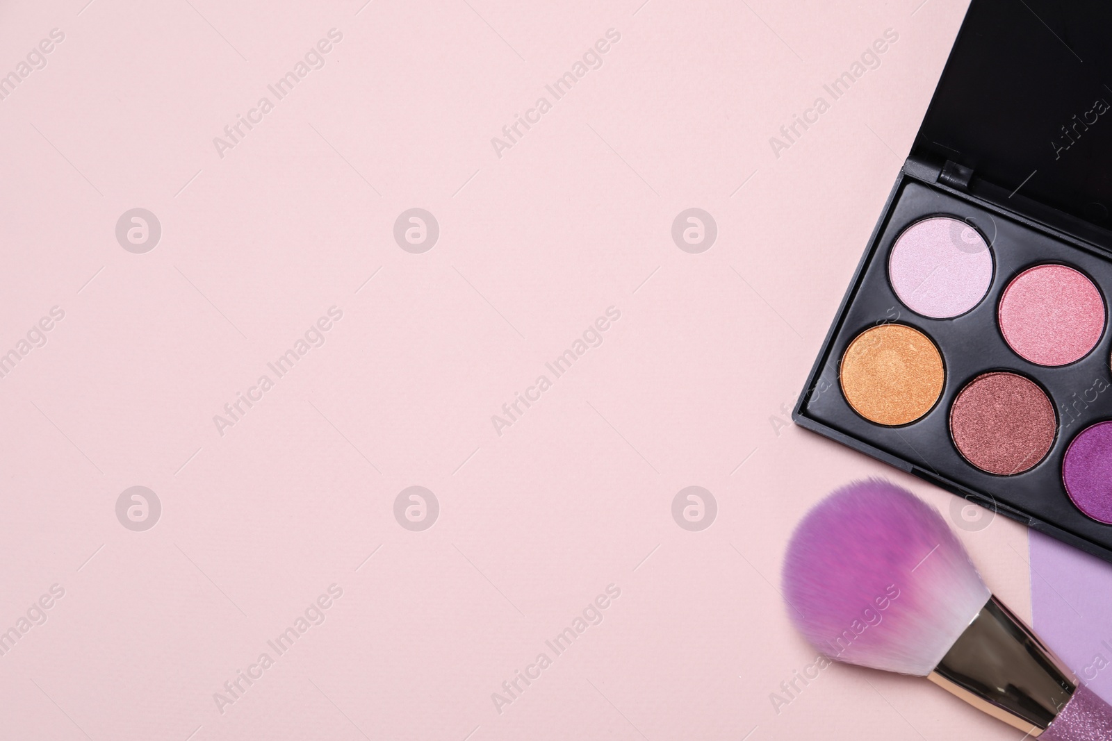 Photo of Eyeshadow palette and makeup brush on color background, flat lay with space for text