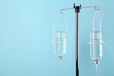 IV infusion set on light blue background. Space for text
