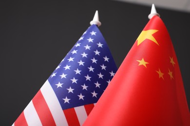 Closeup view of USA and China flags on dark background. International relations