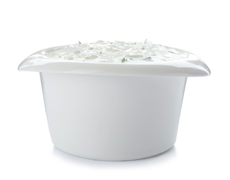 Photo of Bowl with cucumber sauce on white background