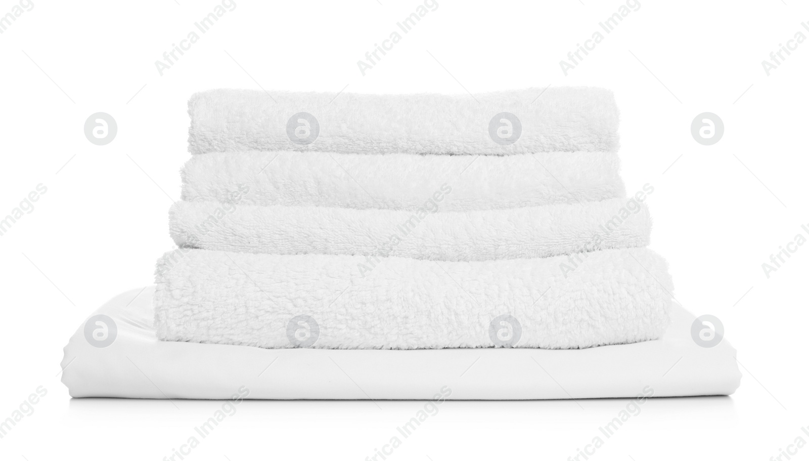 Photo of Stack of towels and bed sheet on white background