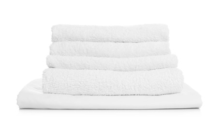 Photo of Stack of towels and bed sheet on white background