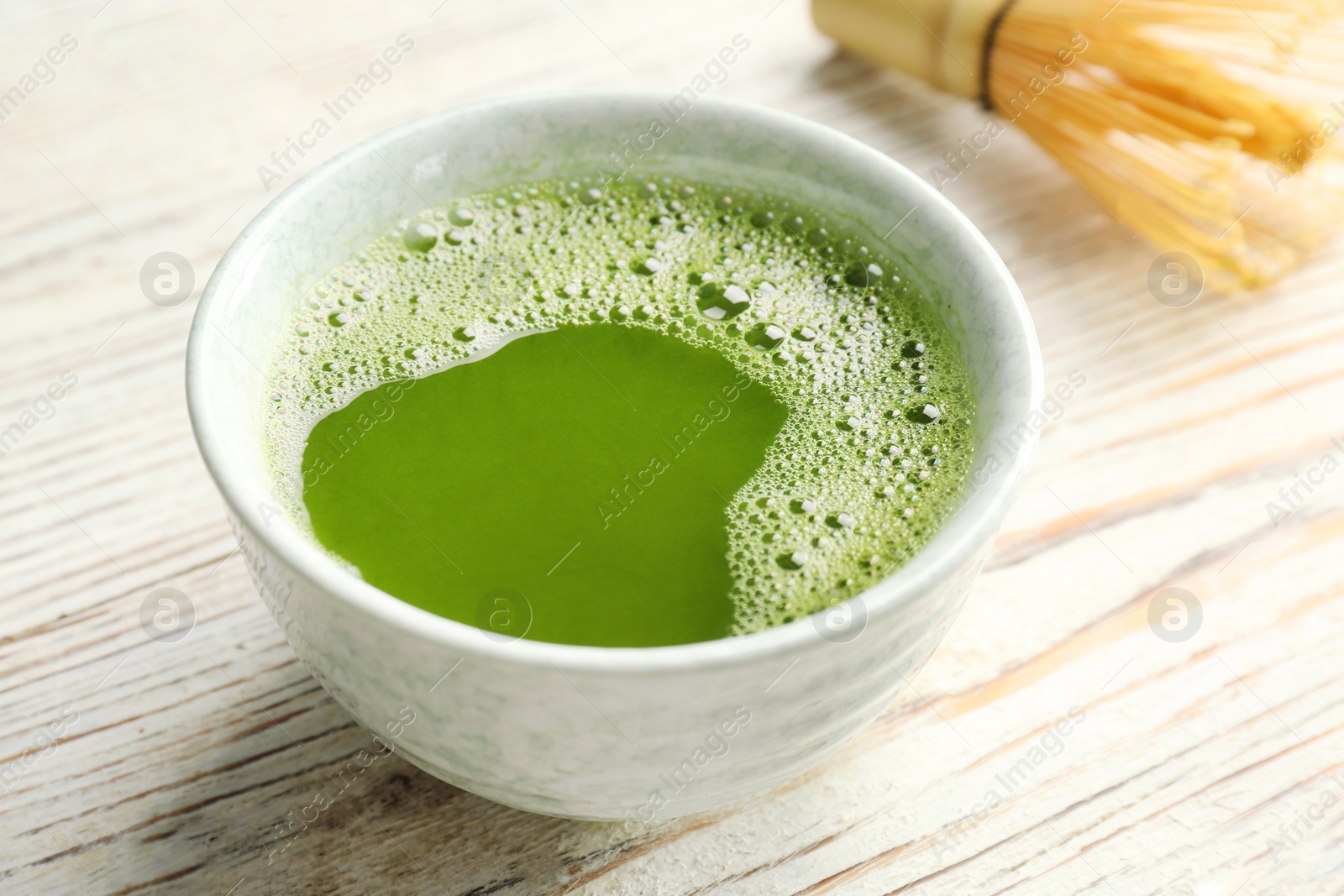 Photo of Chawan with fresh matcha tea on table