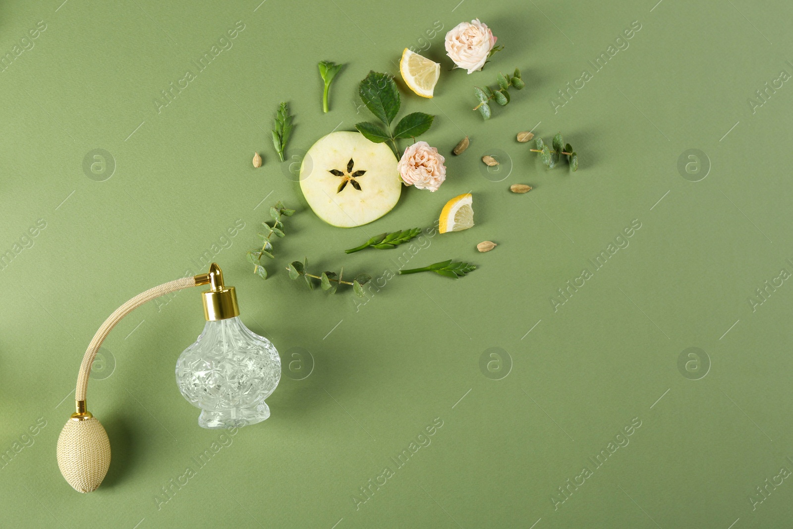 Photo of Flat lay composition with bottle of perfume on green background, space for text