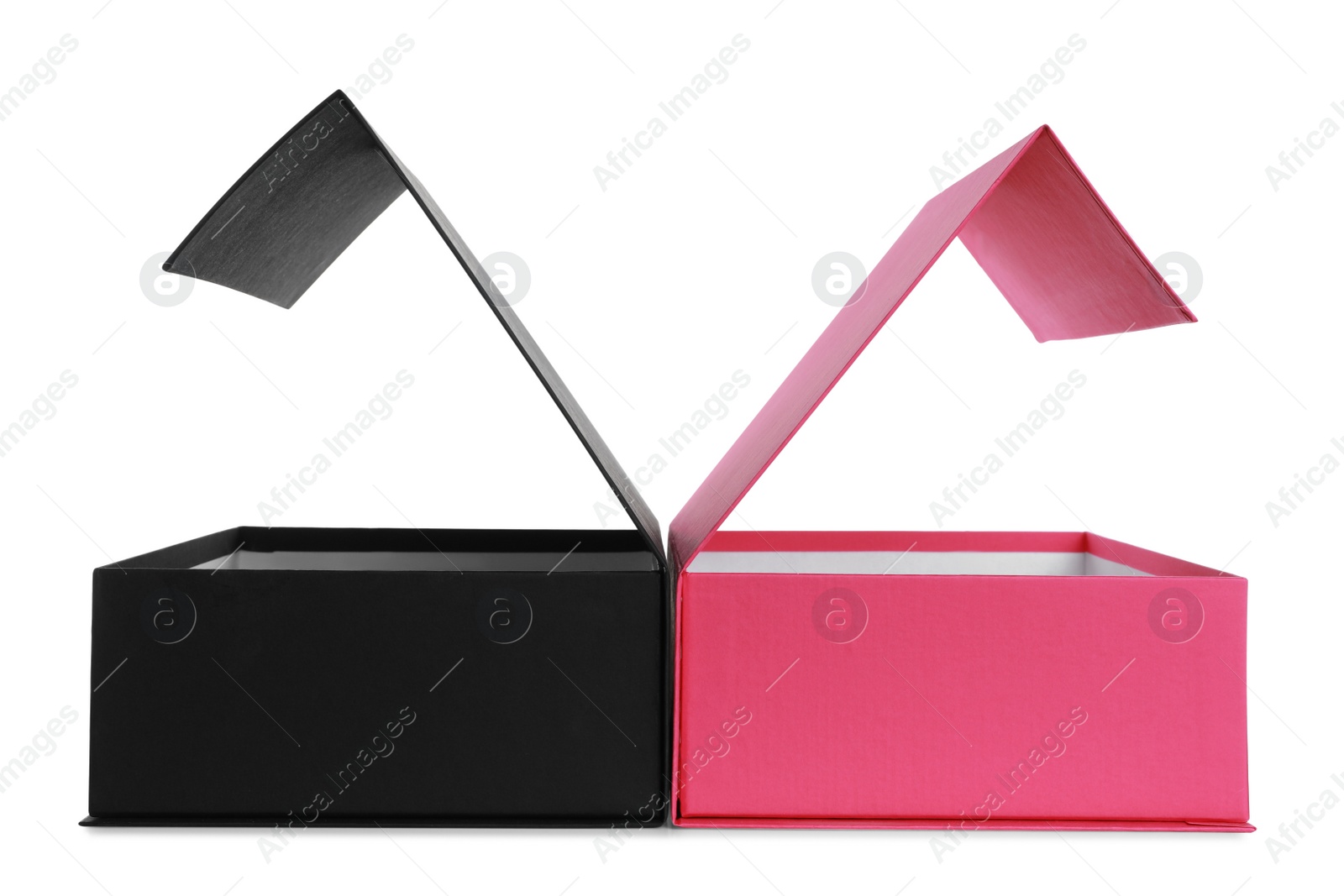 Photo of Open black and pink shoe boxes on white background