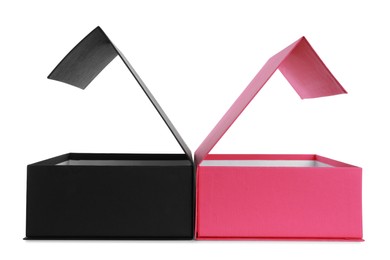 Photo of Open black and pink shoe boxes on white background