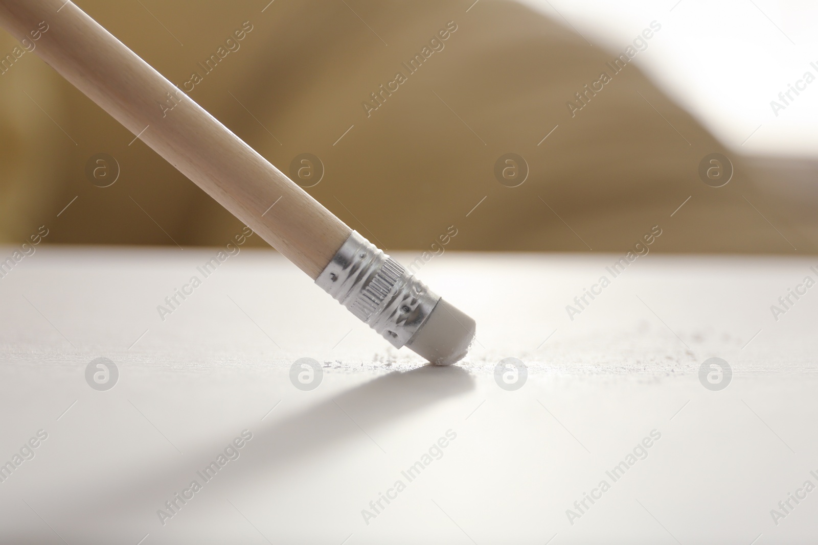 Photo of Correcting picture on paper with pencil eraser, closeup view