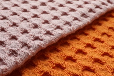 Photo of Orange and pink fabrics as background, closeup