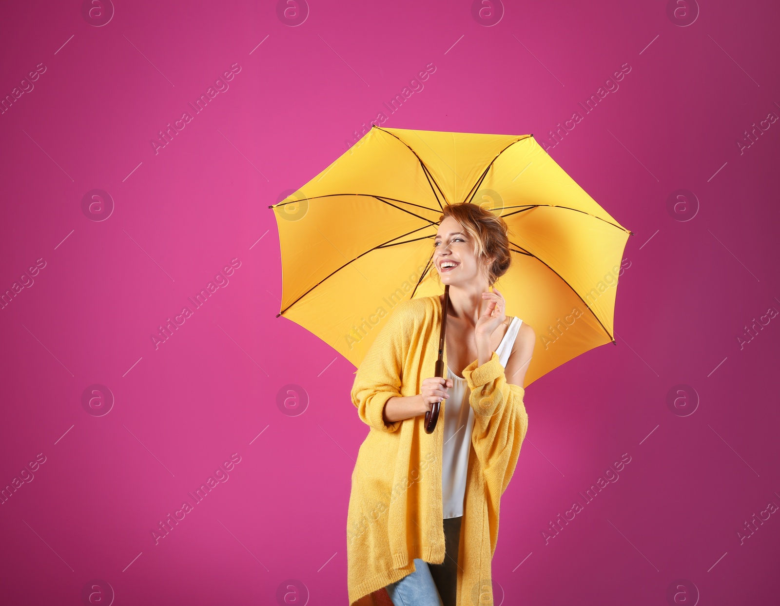 Photo of Woman with yellow umbrella on color background. Space for text