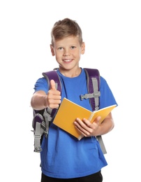 Photo of Cute boy with school stationery showing thumb up on white background