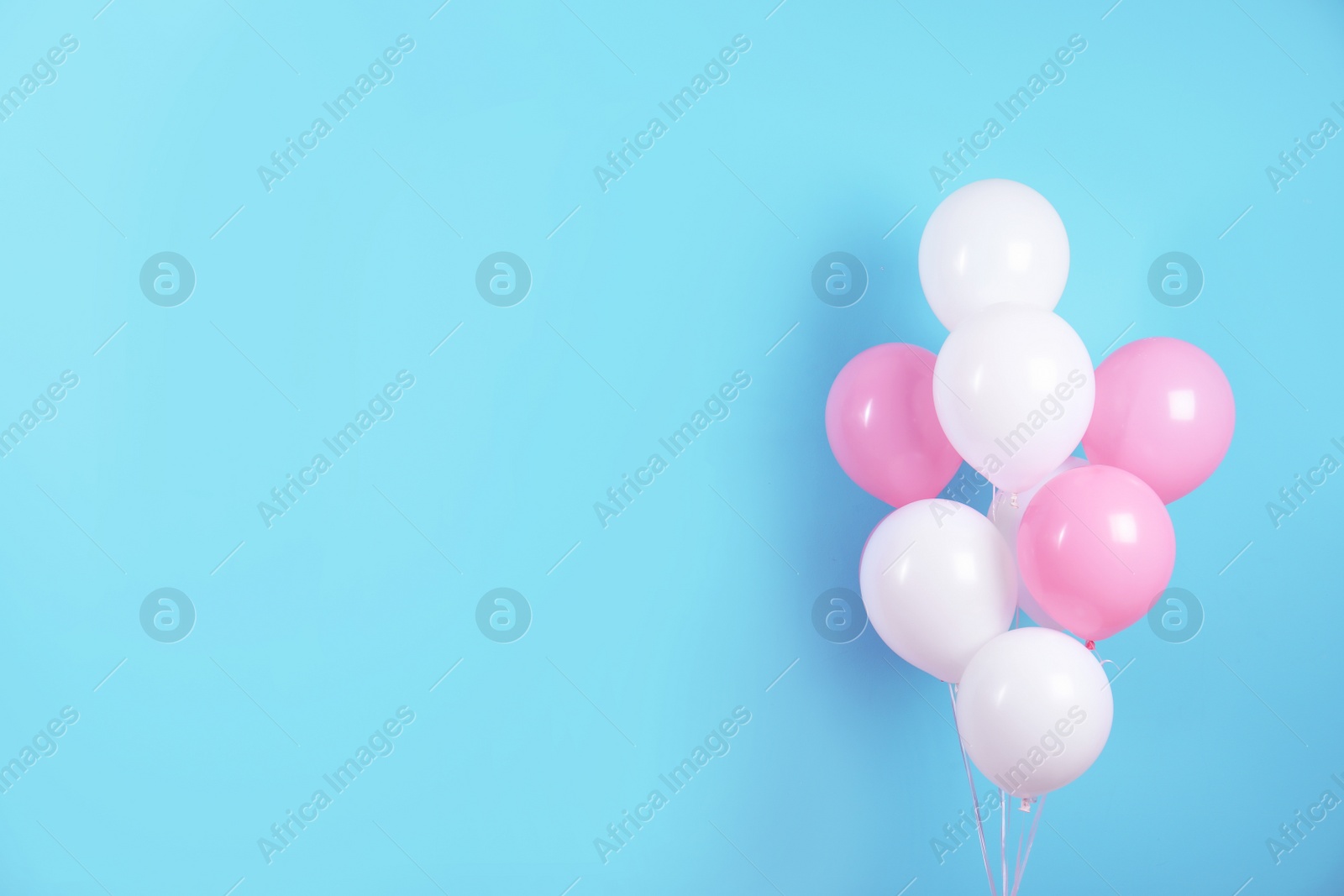 Photo of Colorful party balloons on blue background. Space for text