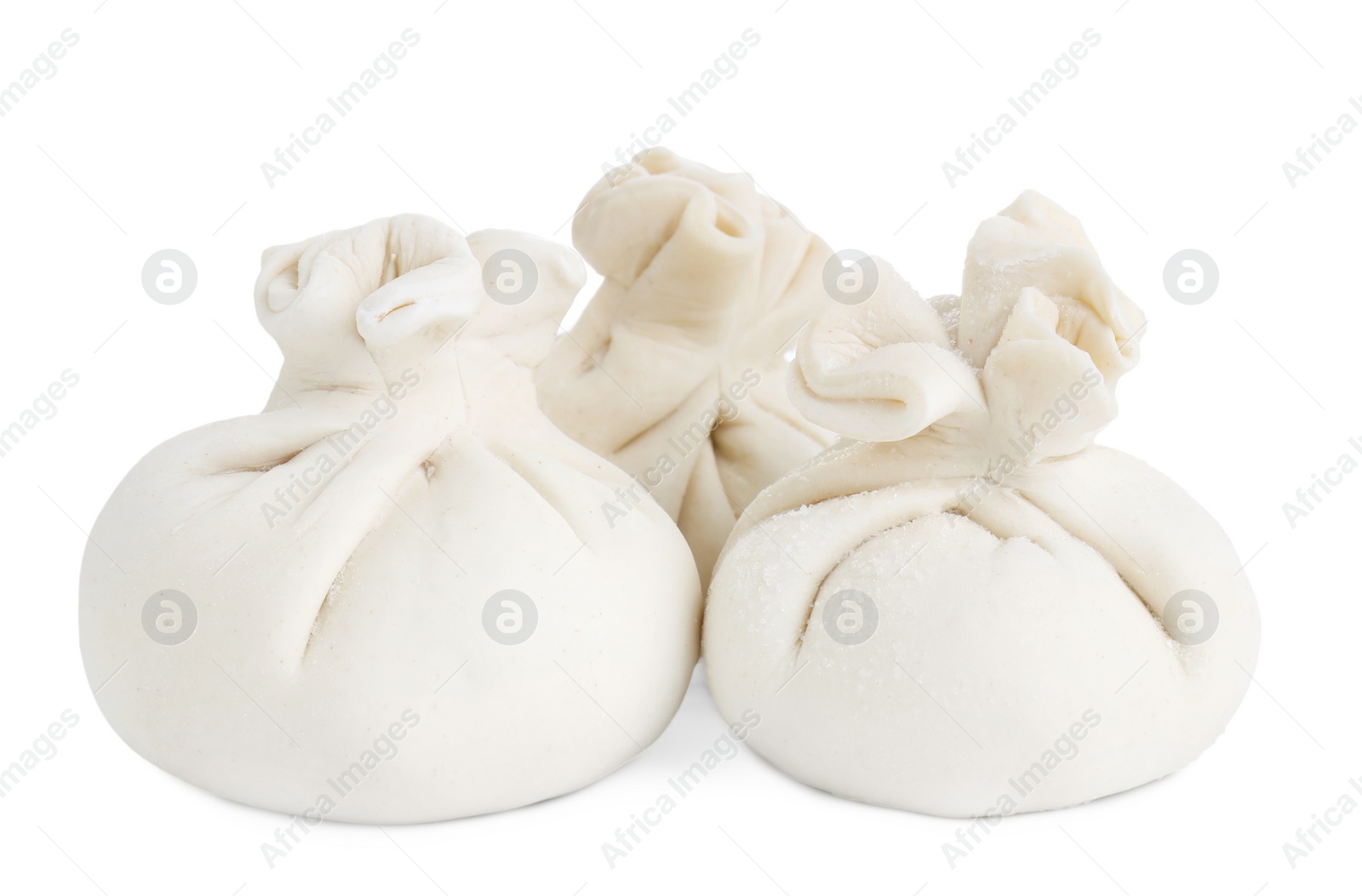 Photo of Uncooked khinkali (dumplings) isolated on white. Georgian cuisine