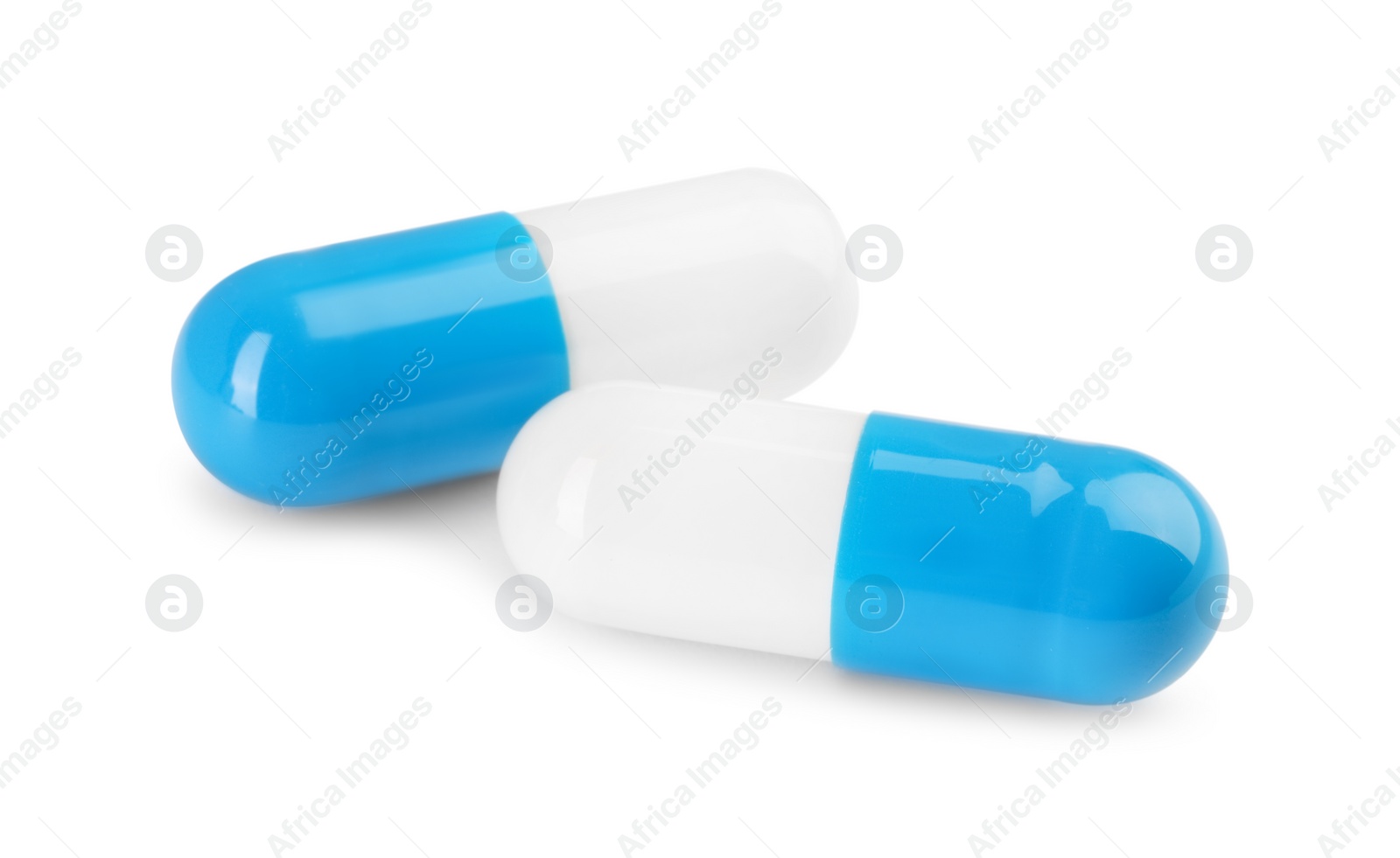 Photo of Two antibiotic pills isolated on white. Medicinal treatment