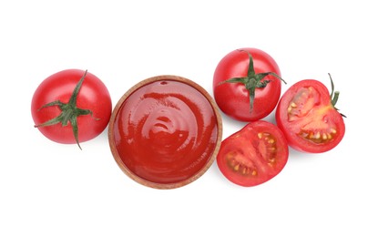Photo of Bowl with tasty ketchup and fresh tomatoes isolated on white, top view