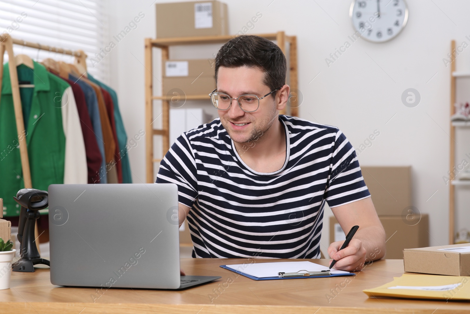 Photo of Seller with laptop working in office. Online store