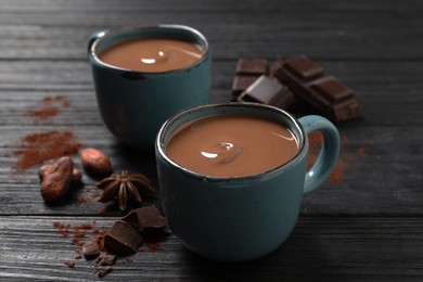 Photo of Yummy hot chocolate on black wooden table