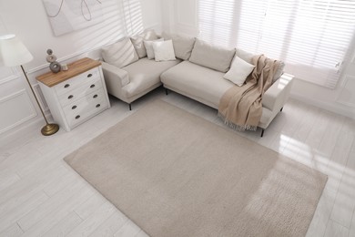 Stylish soft carpet on floor in living room, above view