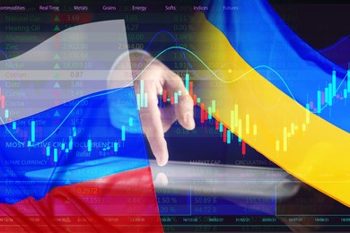 Multiple exposure of Ukrainian, Russian flags, man with tablet and digital stock exchange market charts