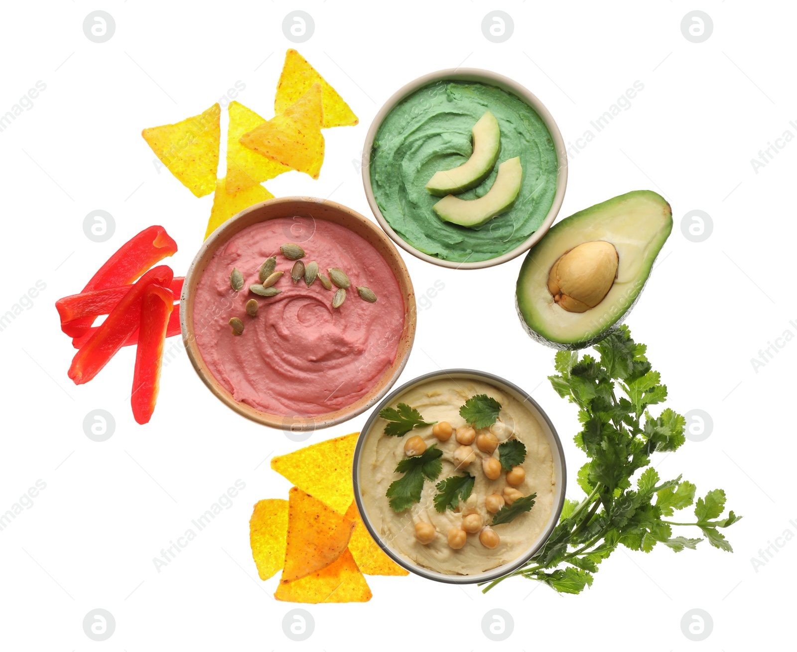 Photo of Different kinds of tasty hummus, nachos and ingredients on white background, top view