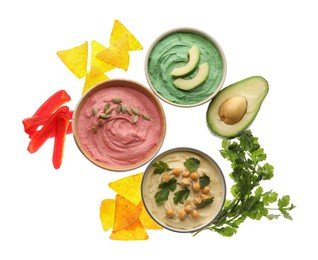 Photo of Different kinds of tasty hummus, nachos and ingredients on white background, top view