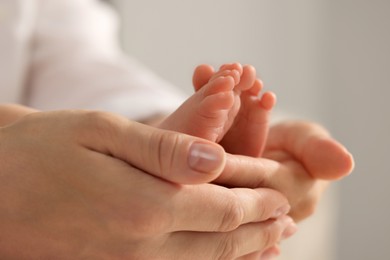 Photo of Mother holding her newborn baby, closeup view