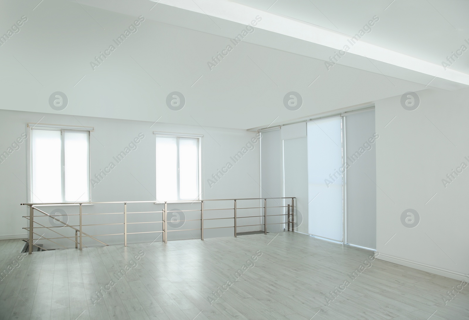 Photo of Large empty hall with windows and railings