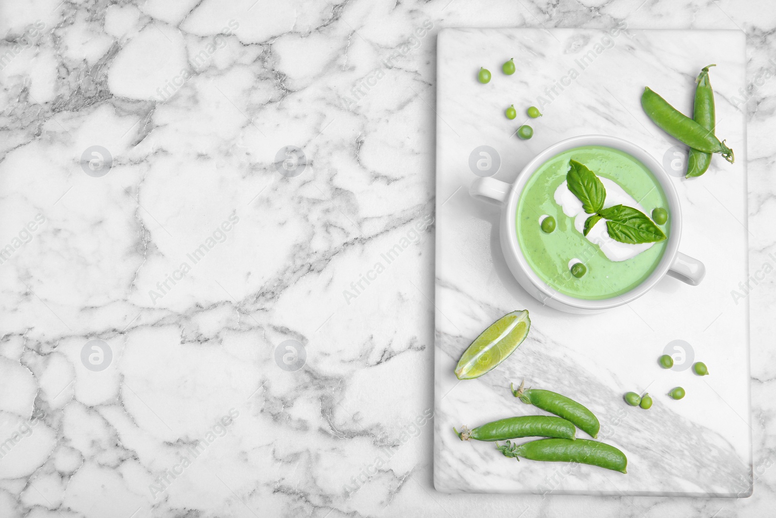 Photo of Flat lay composition with green pea soup on marble background