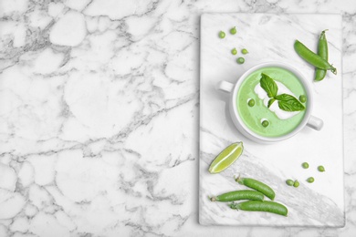 Flat lay composition with green pea soup on marble background