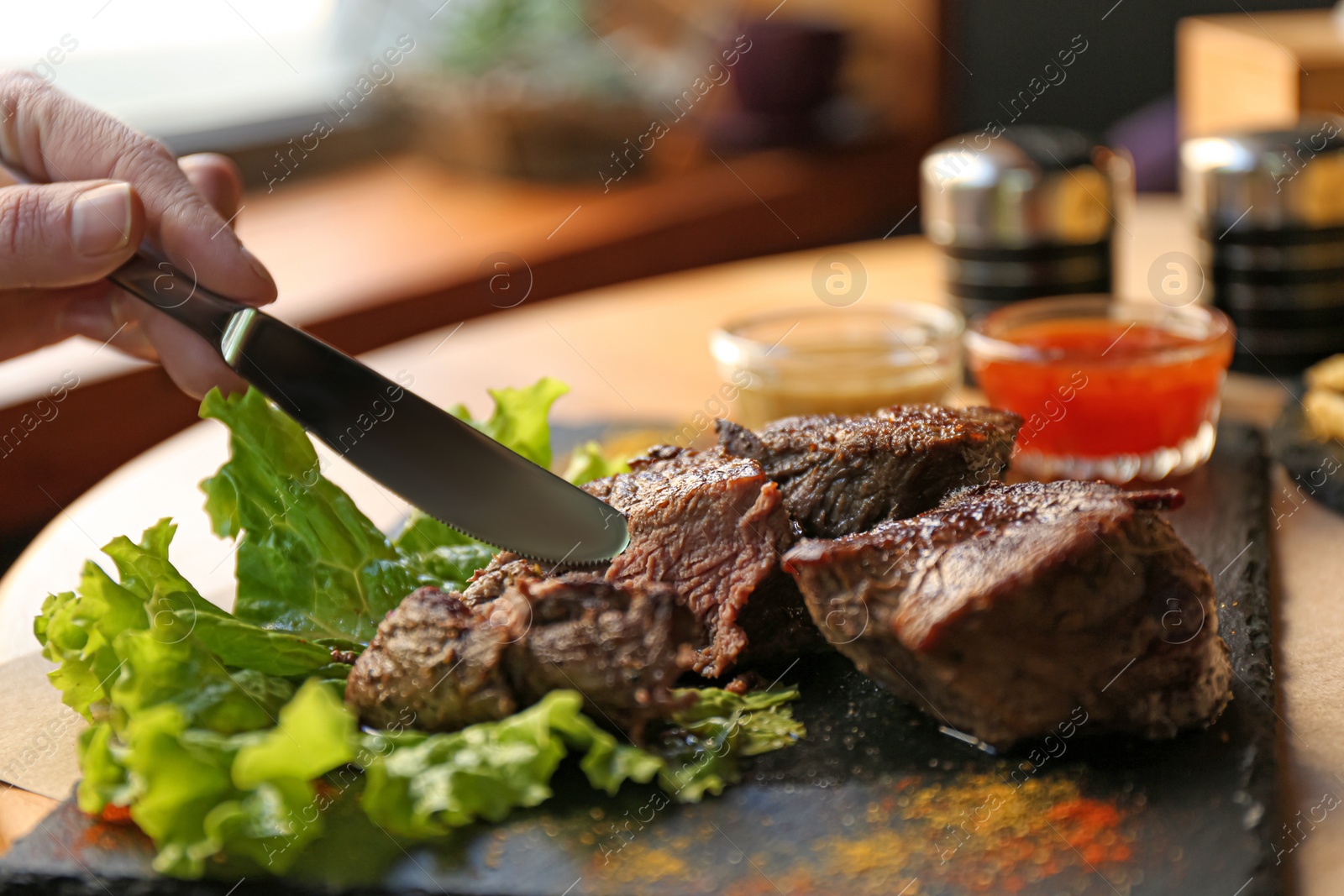 Photo of Woman eating tasty shish kebab in cafe