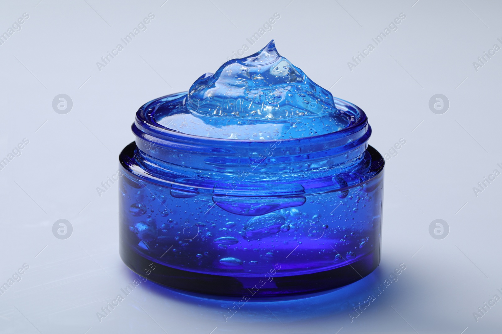Photo of Jar of transparent cosmetic gel on light background