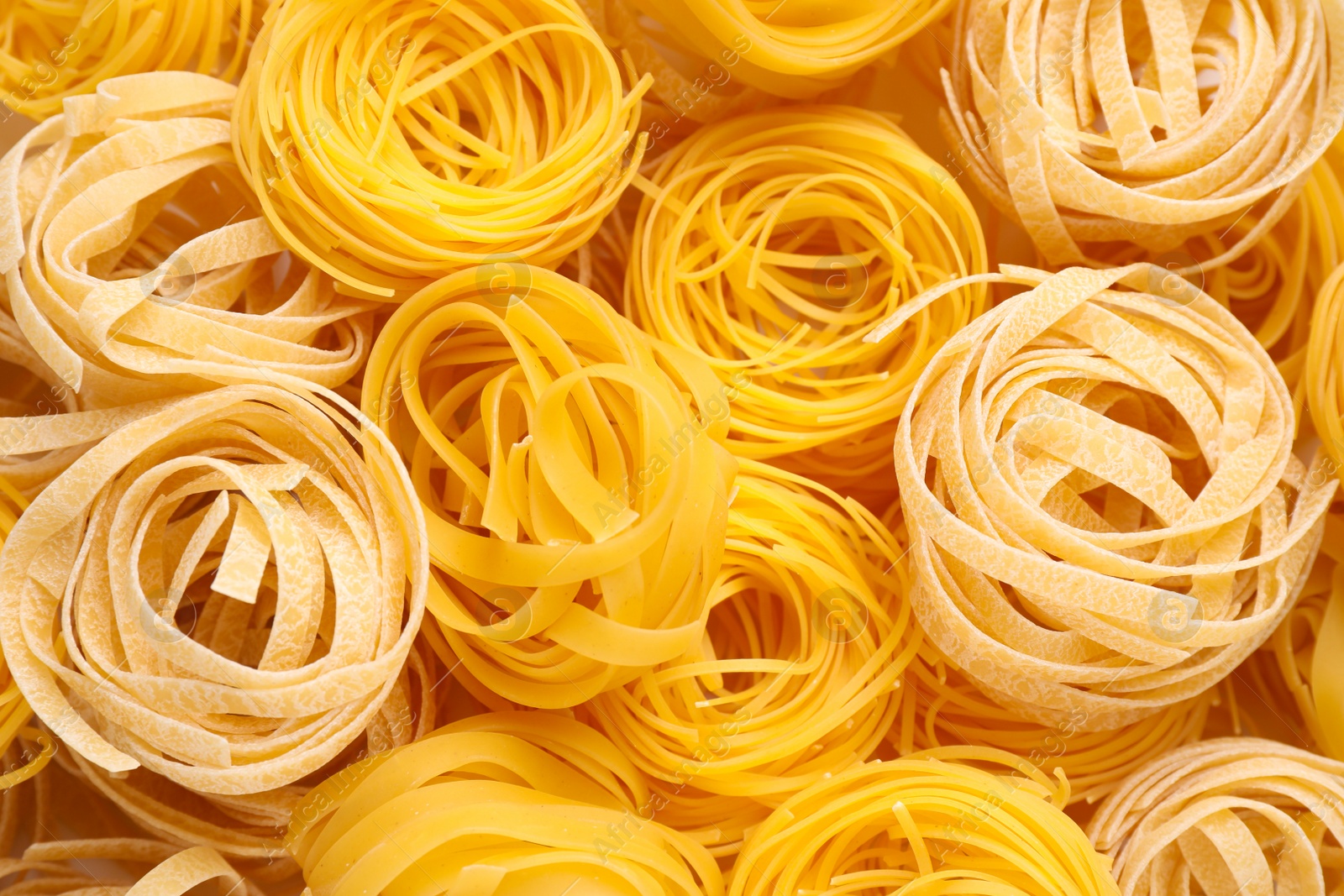 Photo of Different types of pasta as background, top view