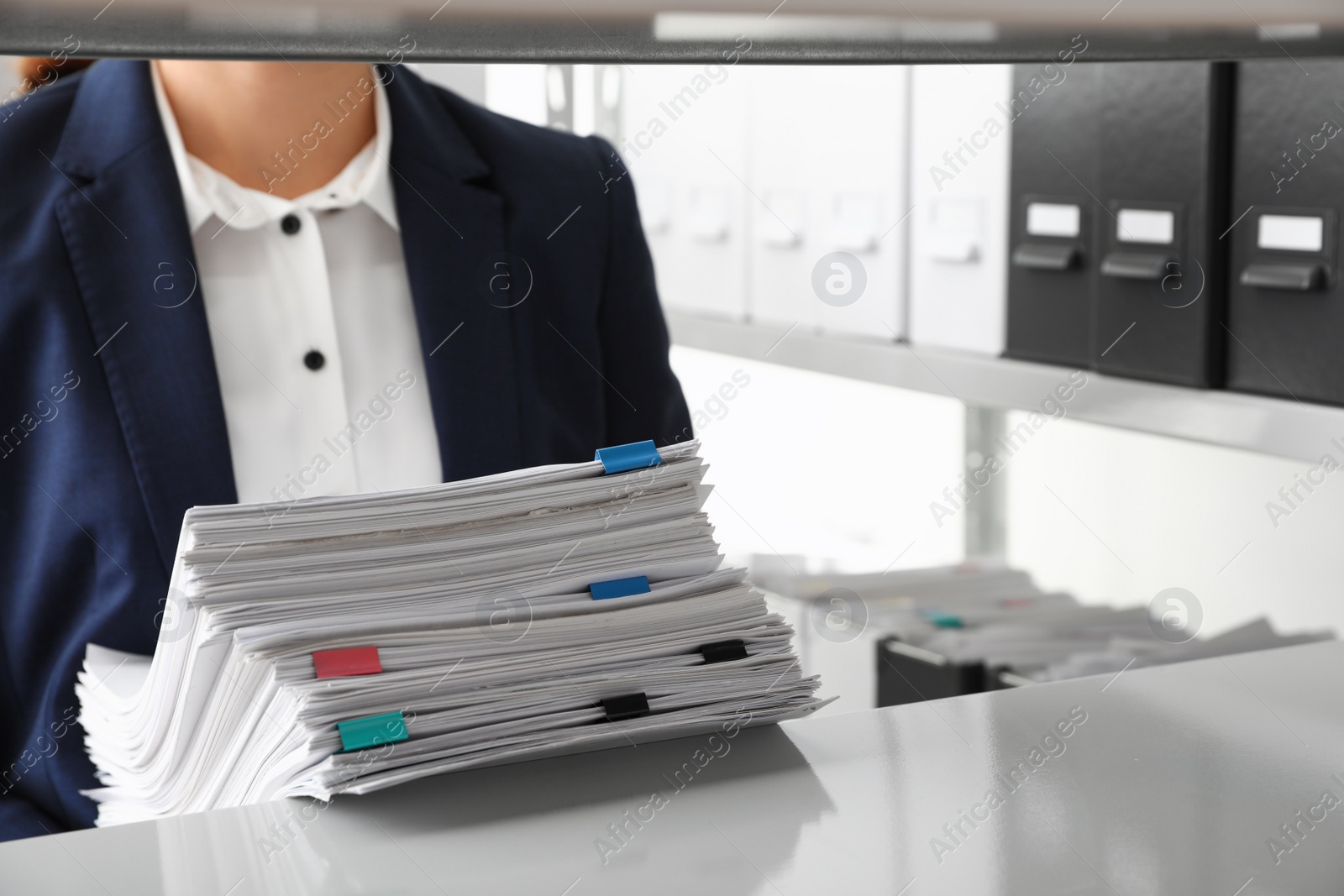 Photo of Female worker with documents in office, closeup. Space for text