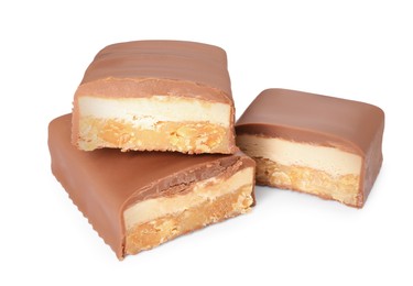 Photo of Pieces of tasty chocolate bars with nougat and nuts on white background