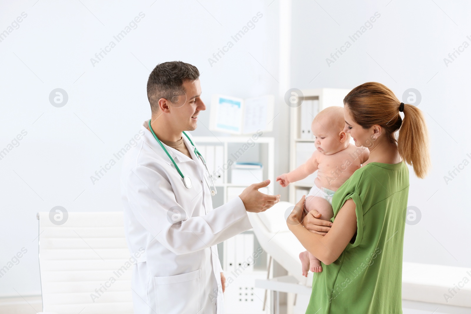 Photo of Woman with her baby visiting children's doctor in hospital