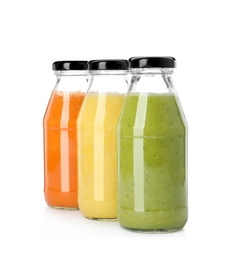 Photo of Bottles of fresh juices on white background