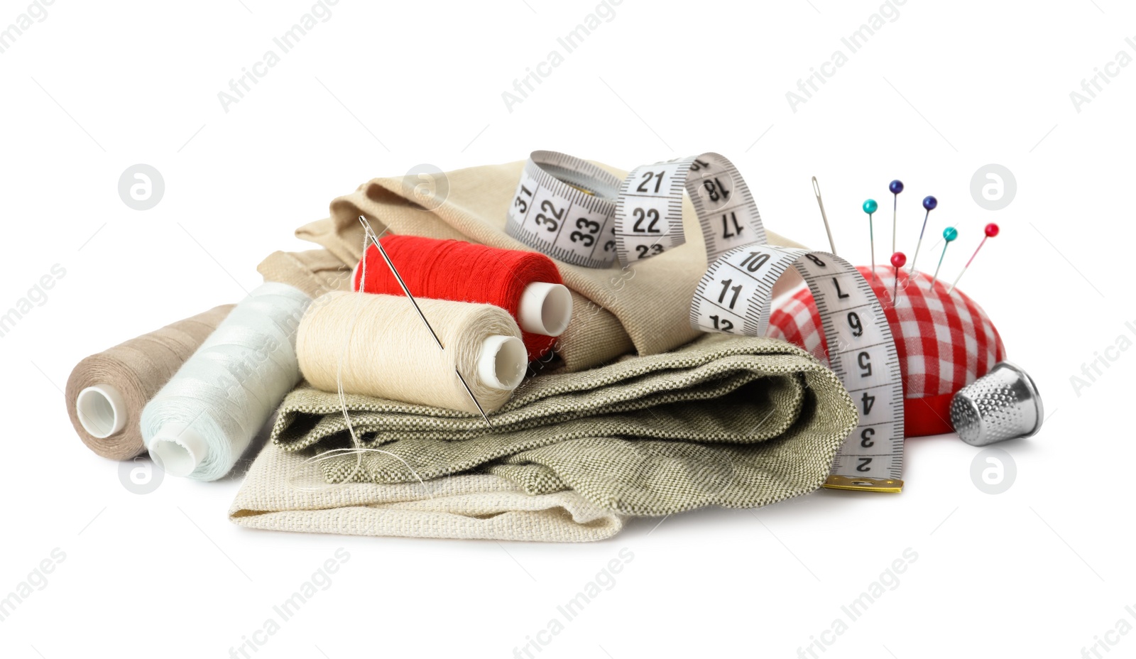 Photo of Spools of threads and sewing tools on white background