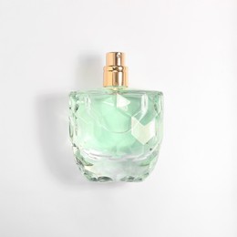 Photo of Luxury women's perfume in bottle on white background, top view