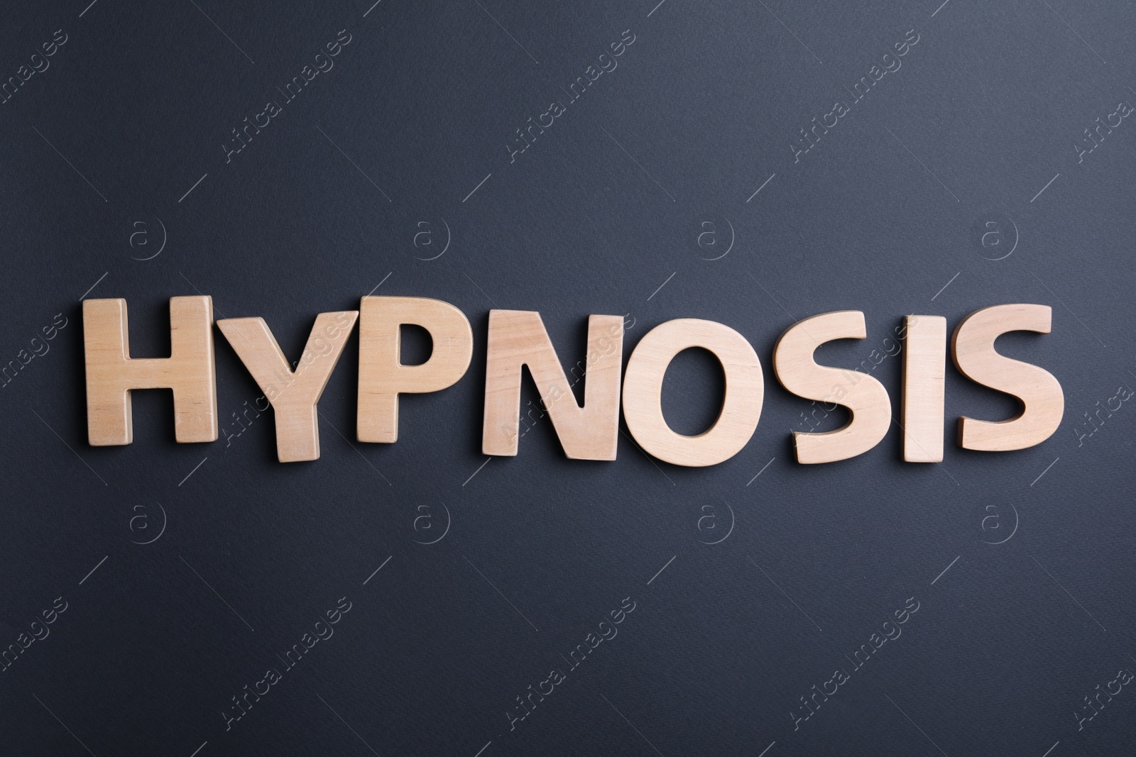 Photo of Word HYPNOSIS made with wooden letters on black background, flat lay